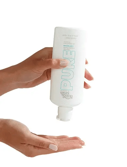 bondi sands pure self tan foaming water light/medium dispensing from pump showing clear texture with hyaluronic acid hydration
